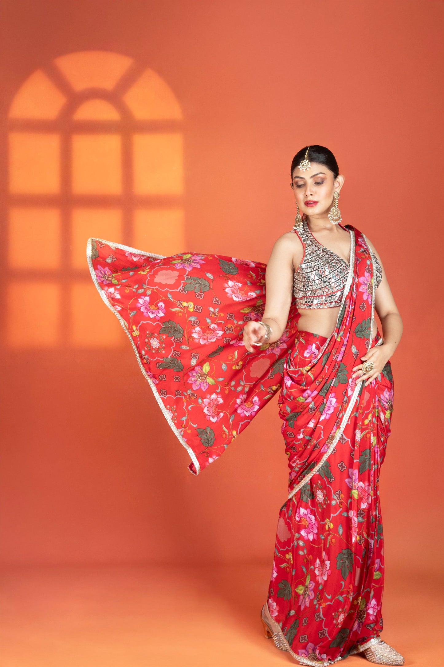 Red floral printed drape saree paired with a heavy mirror-work blouse