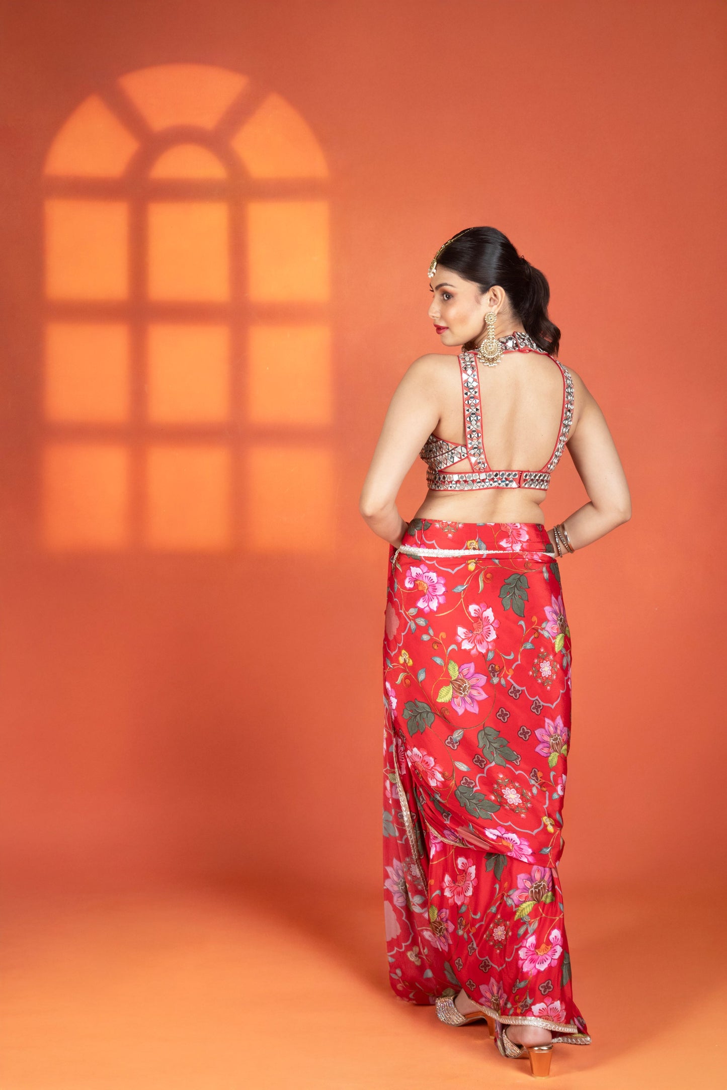 Red floral printed drape saree paired with a heavy mirror-work blouse